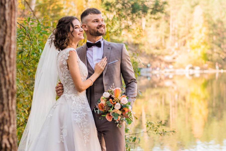 Wedding couple in golden autumn light by a lake